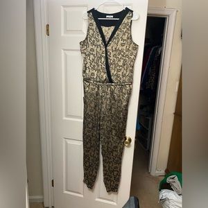 Sleeveless one piece jumper. Drawstring jumpsuit. Pocketed drawstring jumpsuit.